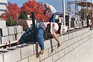 A masonry wall can have various craftspeople working on it at any given time.