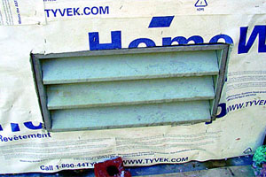 In order for an air barrier to be effective, all of its penetrations and seams need to be sealed. Lack of flashing around this louver will also render this air barrier ineffective if it is intended to serve as a weather-resistive barrier. Also, note that the sheet material has been stapled to the substrate and its seams are not taped. Stapling the membrane to the substrate typically does not provide adequate resistance to wind pressure.