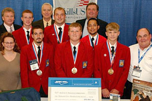 The red-jacketed winners of the secondary division in the front row from left to right are Jared Braveboy, Marcus Hefner and Bradley V. Wright. The post-secondary division winners in the second row from left to right are Travis Greenly, Michael Wagner and Christian Cruz. Members of the Masonry Technical Committee included from left to right are Kellie Hala, Marshalltown Company; Harry Junk, National Concrete Masonry Association; Bryan Light, Brick SouthEast and chair of the Masonry Technical Committee which organized the contest; Bill Kjorlien, masonry tech sales manager, Lafarge North America and former Technical Committee Chair; and Al Herndon, Florida Masonry Apprentice and Education Foundation.