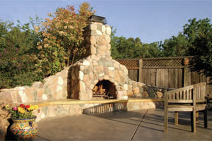 This outdoor fireplace features a chimney cap by Whitecaps. Image courtesy of Morse Remodeling in Davis, Calif.