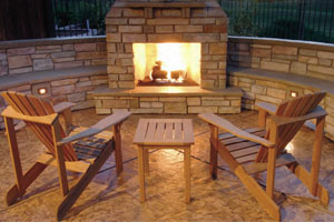 Fireplaces serve as a gathering spot in outdoor spaces, offering light and warmth. Image courtesy of Morse Remodeling in Davis, Calif.