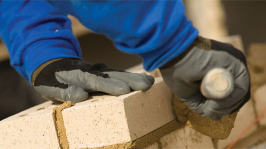 OSHA is requiring bricklayers to wear protective gloves.