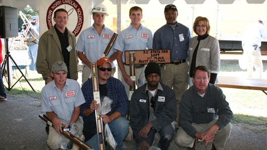 Pictured from left to right: (top row) Gary Manning (contest judge), Jared Gandy (2nd place), Rhett Hallman (1st place winner), Calvin Brodie (contest planning committee), and Labor Commissioner Cherie Berry; (bottom row) Justin Helms (5th place), Chris Lunsford (4th place), Macy Williams (3rd place), and Doug Burton (head judge).
