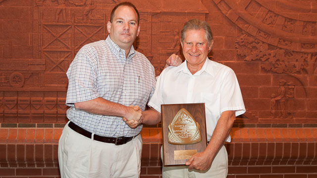 Bill Daidone (L) presents the Harry E. Ebright award to Garth Tayler of Acme Brick Co.