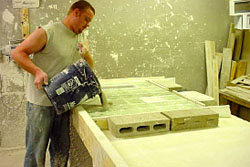 Quickset Panel employee pours mortar slurry onto pre-assembled panel