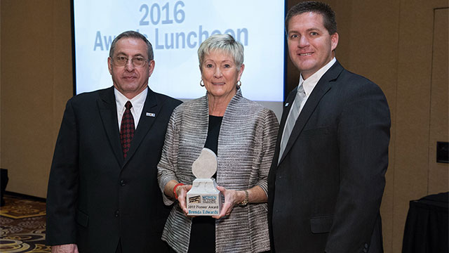 Brenda Edwards with 2016 BSI President Aaron Hicken and 2016 MIA President David Castellucci.