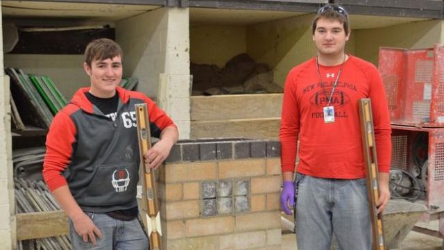 Blaze Fox-Quillen and Ryan Daberko in the BCC masonry lab with their new levels.