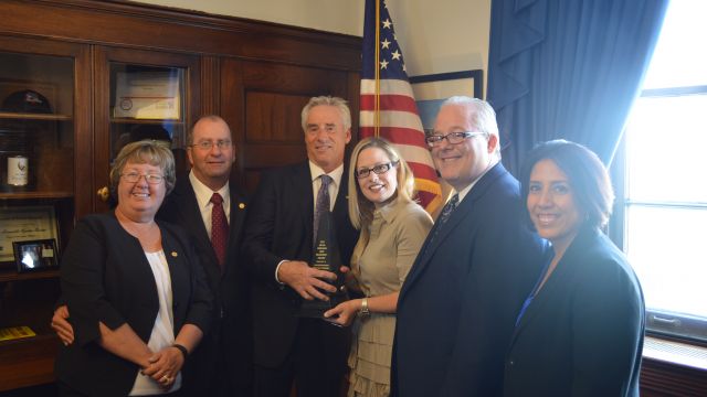 Mark Kemp (left center) presents the MCAA Freedom and Prosperity Award to Representative Kyrsten Sinema (D-AZ) with (from left to right) Colleen Sutter, Mike Sutter, Jeff Buczkiewicz, and Lisa Prichard.