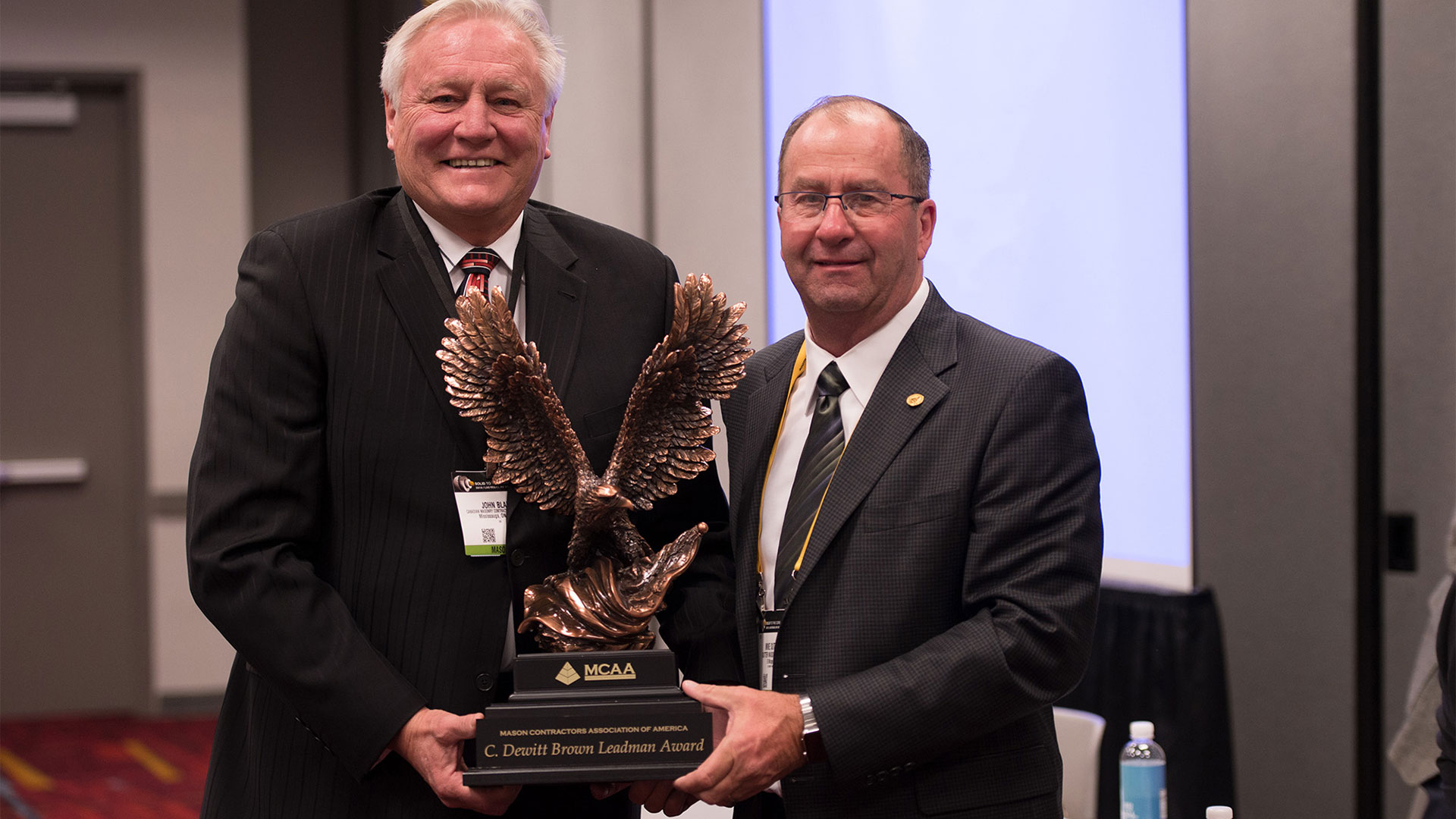 MCAA Chairman Mike Sutter (right) presents John Blair (left) with the C. DeWitt Brown Leadman Award.