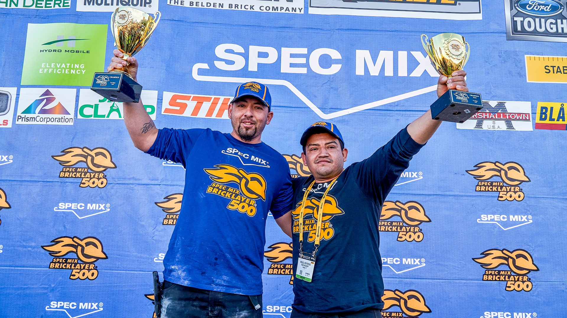 Bricklayer David Chavez (left) and his mason tender, Miguel Contreras (right), celebrate winning the 2018 SPEC MIX BRICKLAYER 500® World Championship.