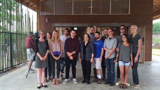 Assistant Professor Jennifer Akerman (left, AIA, LEED AP, UT College of Architecture and Design) and Mayor Rogero (center) pose in front of the new Beardsley Farm facility with some of the UT architecture students who contributed to the building.