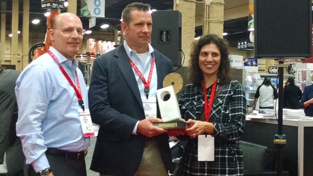 Stone World’s Dave Madonia and Jennifer Richinelli present Eric Tryon with the Fabricator of the Year Award at TISE 2016.