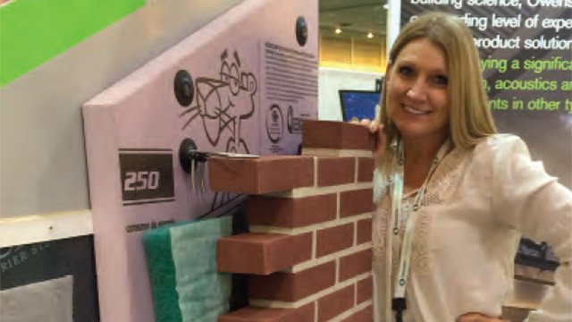 Jennifer Morrell checks out a model of the CavityComplete Wall System during Greenbuild 2014, held in New Orleans in October