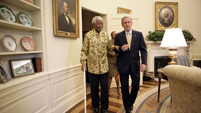 President George W. Bush and former President Nelson Mandela of South Africa meet in the Oval Office Tuesday, May 17, 2005. White House photo by Eric Draper