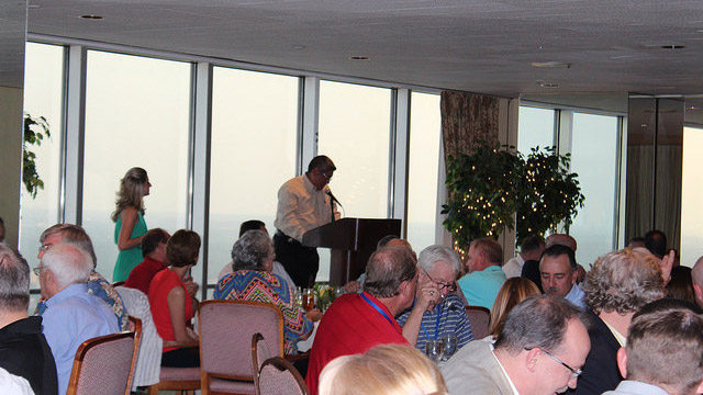 TMC President Romeo Collazo announces that the TMC raised more than $90,000 at the annual Golf Tournament and Live Auction.