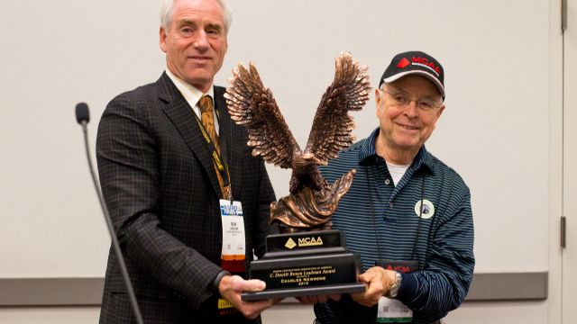 MCAA Chairman Mark Kemp (left) presents Charles Newsome (right) with the C. DeWitt Brown Leadman Award.
