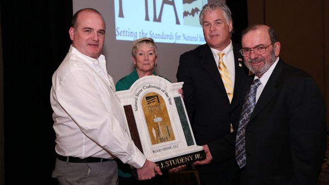 Regis Studeny (far right) accepts the 2015 Natural Stone Craftsman of the Year award from award sponsors Patrick Perus (Polycor) and Brenda Edwards (TexaStone Quarries) and 2015 MIA President, Dan Rea (Coldspring).