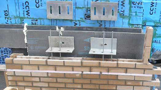 The structural brick connection to lateral and vertical load anchors