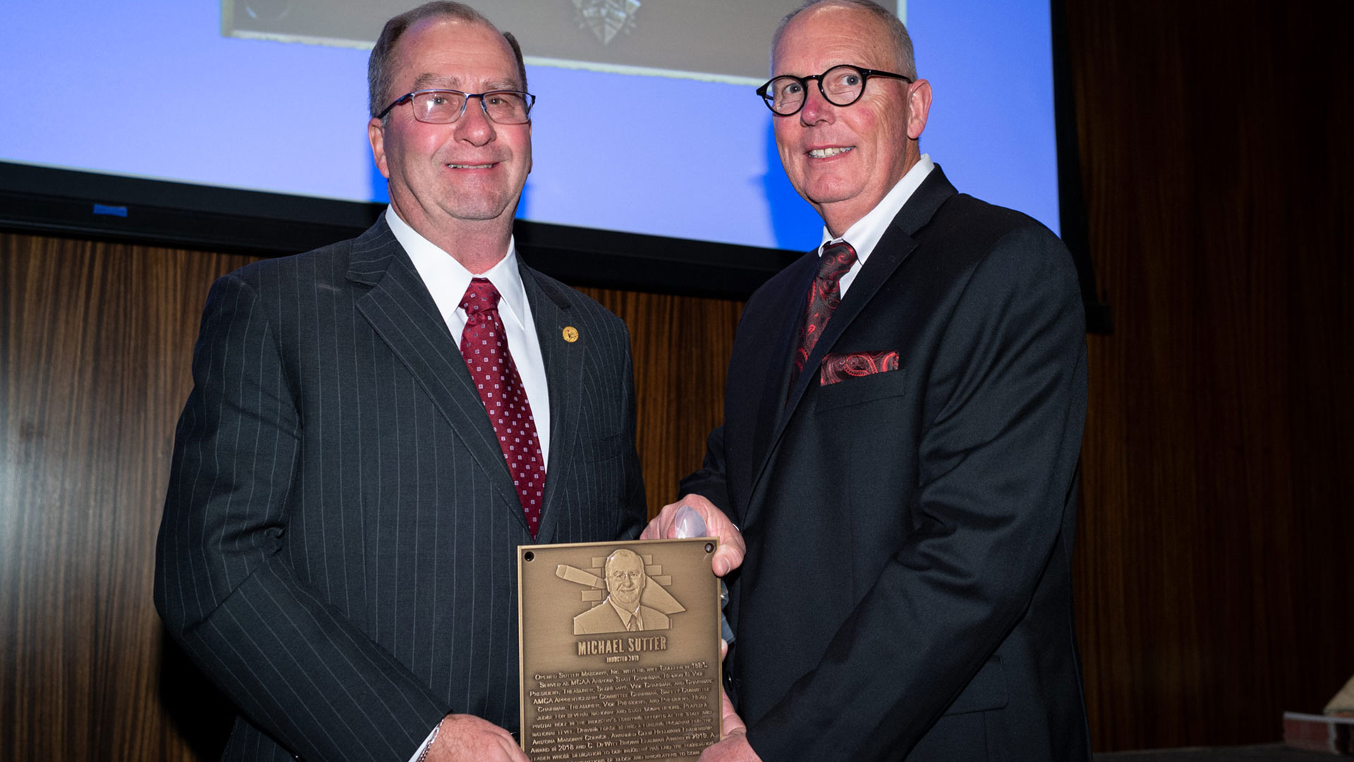 MCAA Chairman Paul Odom (right) presents Michael Sutter with his Masonry Hall of Fame plaque.