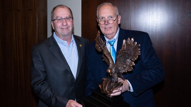MCAA Chairman Paul Odom (right) presents Mike Sutter (left) with the C. DeWitt Brown Leadman Award