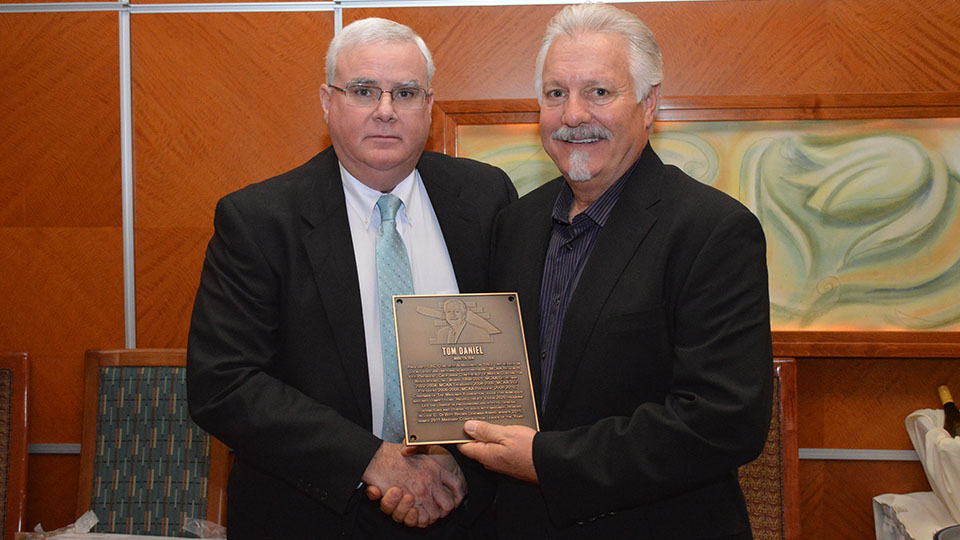 MCAA Chairman John Smith (left) presents Tom Daniel (right) with the Masonry Hall of Fame plaque