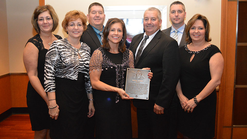The Vasquez family accepts the Masonry Hall of Fame plaque