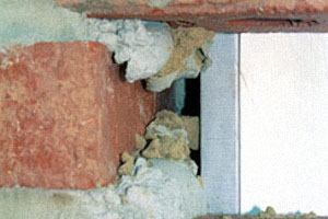 When the brick is pressed into place, the excess mortar clings to the back of the brick and can fall to the bottom of the wall, clogging weep holes.