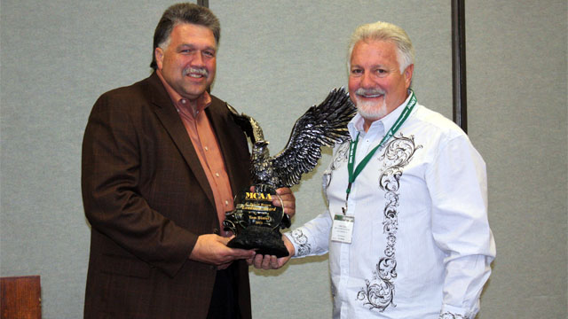 MCAA President Mackie Bounds (left) presents Tom Daniel (right) with the 2011 C. DeWitt Brown Leadman Award.
