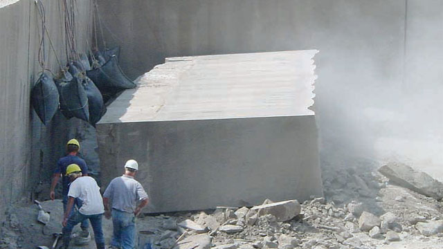 Once Limestone block is sawn, compressed air bags inflate to force the 12-ton block onto its side in preparation for extraction from this Indiana Limestone Co. quarry.