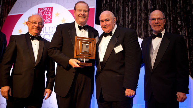 Cary Evert (second from left), President and CEO of Hilti North America, and William Caporizzo (second from right), New York City division manager, accept the Great Place to Work Award.