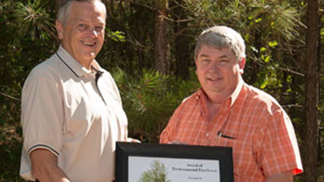 Dennis Knautz, President and CEO of Acme Brick Company (L) presents Acme's Environmental Award to Rick Hice, a Regional Engineer with Acme who developed the Reforestation Program.