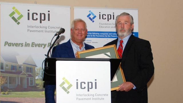 Chuck Taylor receives the 2016 ICPI Lifetime Achievement Award from Steve Berry at ICPI's Summer Meeting in Nashville, Tenn.