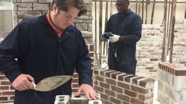 Steven Uhler and Dominick Johnson work in masonry class at Dothan Technology Center.