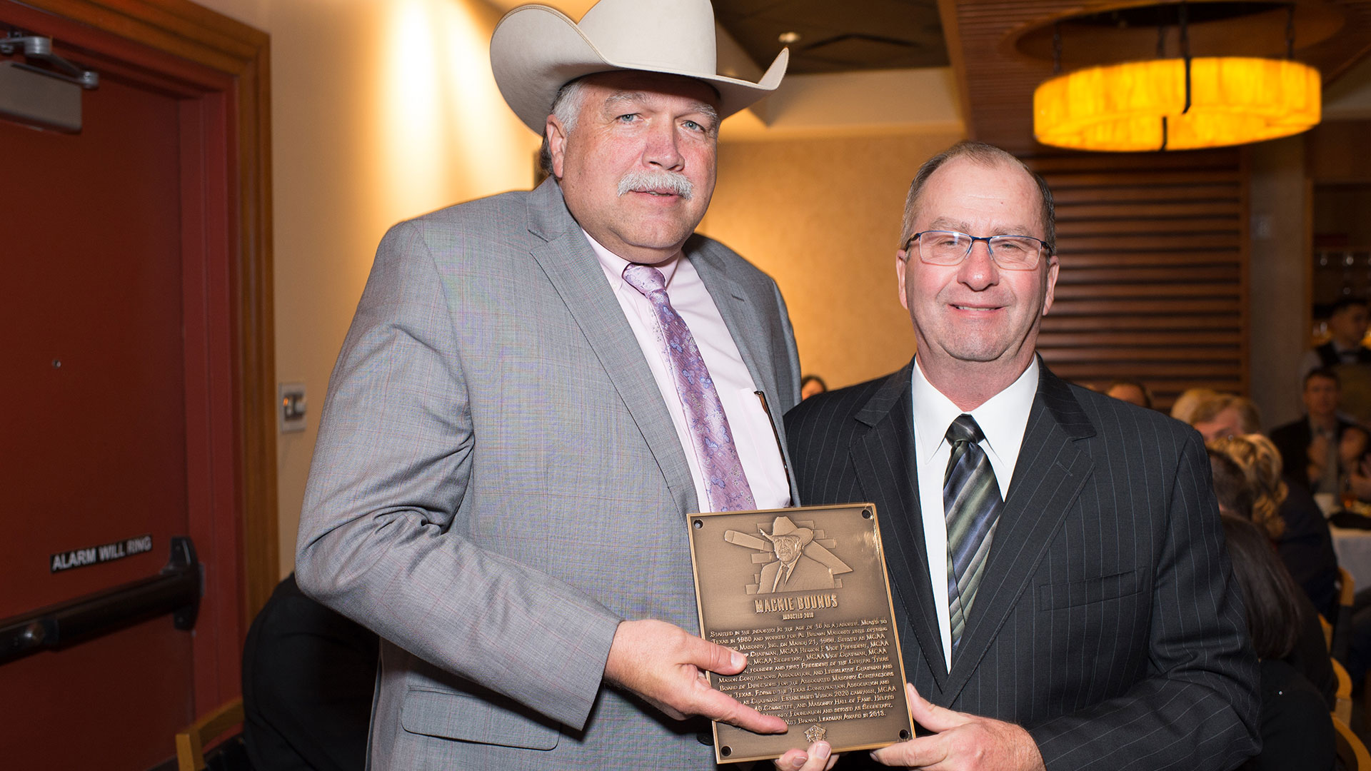 MCAA Chairman Mike Sutter (right) presents Mackie Bounds with his Masonry Hall of Fame plaque.