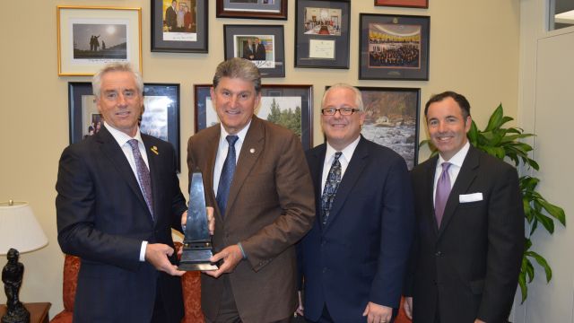 Mark Kemp (left) presents the MCAA Freedom and Prosperity Award to Senator Joe Manchin (D-WV) with Jeff Buczkiewicz and Matt Keelen
