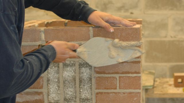 Andy Schlichte of Cedar Rapids nears completion of his Masonry competition project in Jones Hall at Kirkwood Community College