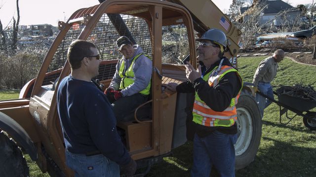 Barry Salerno (right), OSHA assistant area director in Peoria, Ill., talks with bobcat operator Tim Mueller and Allen Ricketts about potential safety hazards